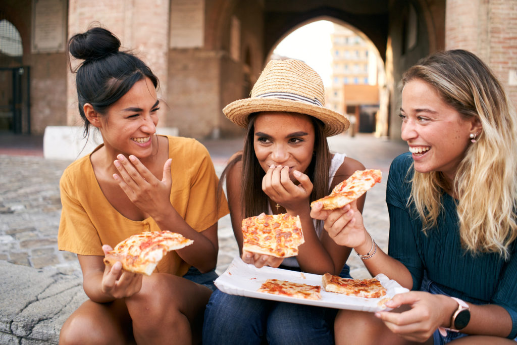 Eating pizza in the streets of Italy